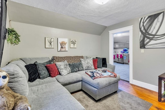 38 Cliff St, Fitchburg, MA 01420 - living area with wood finished floors, baseboards, a textured ceiling, and vaulted ceiling
