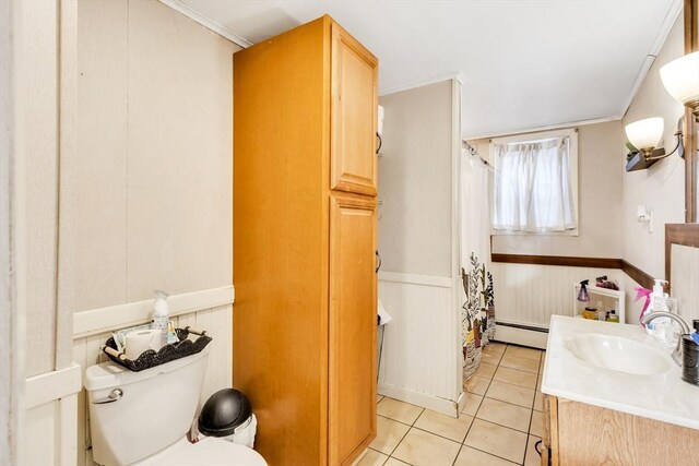 38 Cliff St, Fitchburg, MA 01420 - full bathroom featuring baseboard heating, toilet, tile patterned floors, vanity, and a wainscoted wall