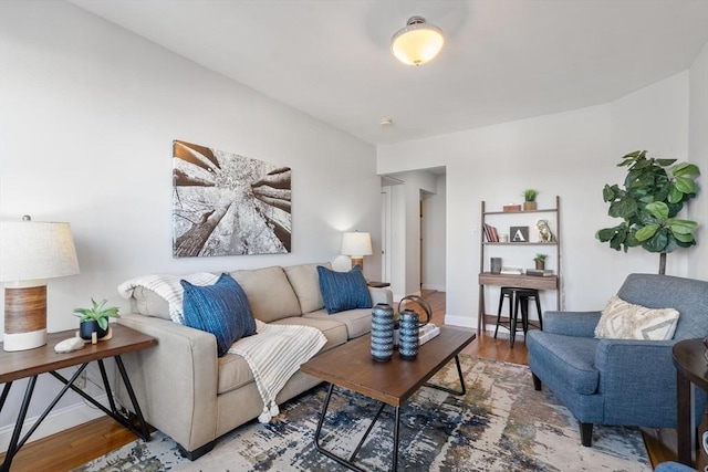 living area featuring baseboards and wood finished floors