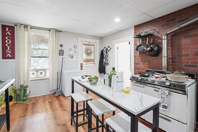 19 Chester St, Fitchburg, MA 01420 - kitchen with white range with gas cooktop, a paneled ceiling, light wood finished floors, and healthy amount of natural light