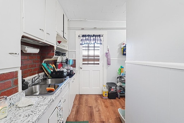 19 Chester St, Fitchburg, MA 01420 - kitchen with a sink, white cabinetry, light wood-style flooring, and light countertops