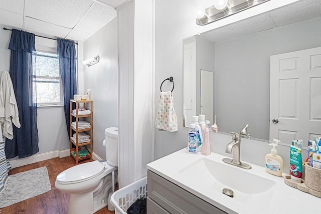 19 Chester St, Fitchburg, MA 01420 - bathroom with a paneled ceiling, wood finished floors, toilet, vanity, and baseboards