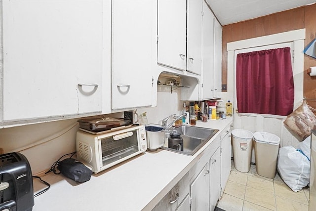 19 Chester St, Fitchburg, MA 01420 - kitchen with white cabinetry, a sink, and light countertops
