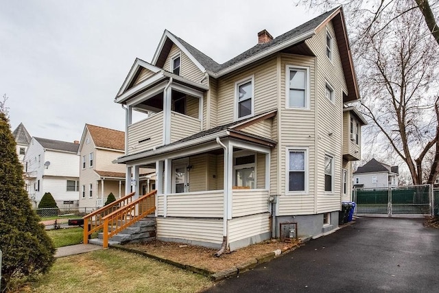 67 Alexander St, Springfield, MA 01107 - view of front of property with a porch, a chimney, and a balcony