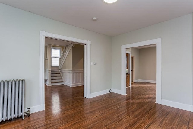 67 Alexander St, Springfield, MA 01107 - unfurnished room featuring radiator, wood finished floors, a smoke detector, and stairs