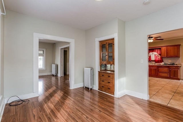 67 Alexander St, Springfield, MA 01107 - spare room with radiator heating unit, light wood finished floors, and a ceiling fan
