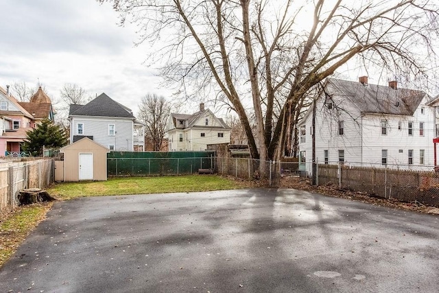 67 Alexander St, Springfield, MA 01107 - fenced backyard with a storage unit and a residential view