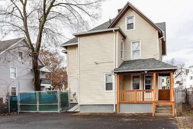 67 Alexander St, Springfield, MA 01107 - view of front of home featuring covered porch, a gate, a shingled roof, and a chimney