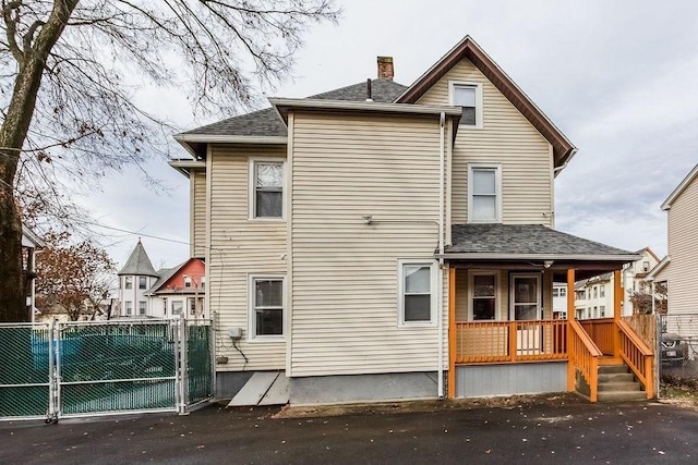 67 Alexander St, Springfield, MA 01107 - back of house featuring covered porch, a chimney, a shingled roof, and a gate
