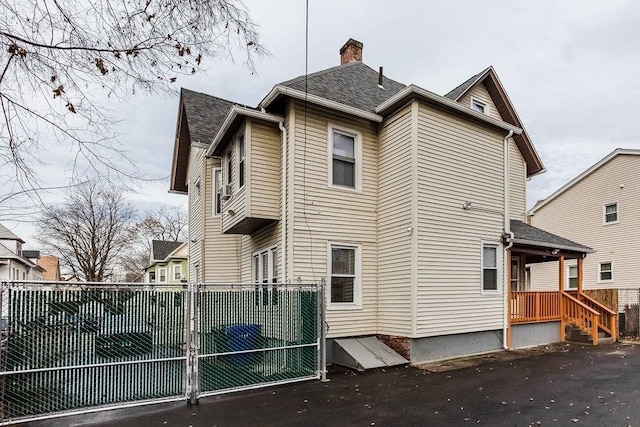 67 Alexander St, Springfield, MA 01107 - view of side of property with a chimney and roof with shingles