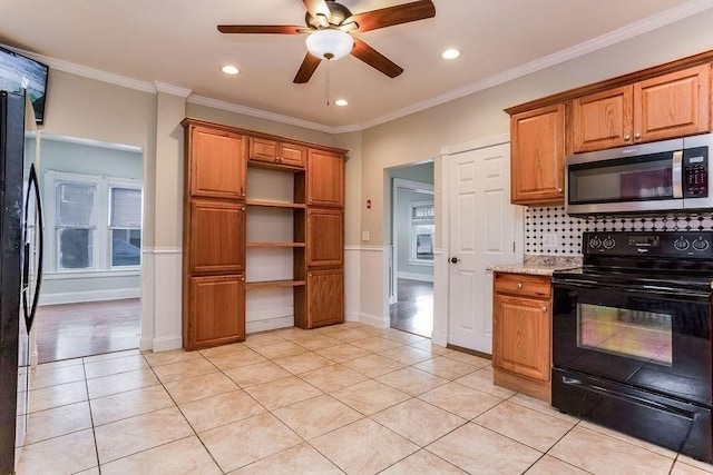 67 Alexander St, Springfield, MA 01107 - kitchen featuring black appliances, light tile patterned floors, backsplash, brown cabinets, and recessed lighting