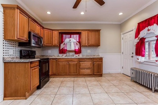 67 Alexander St, Springfield, MA 01107 - kitchen featuring black / electric stove, radiator heating unit, stainless steel microwave, brown cabinets, and ornamental molding