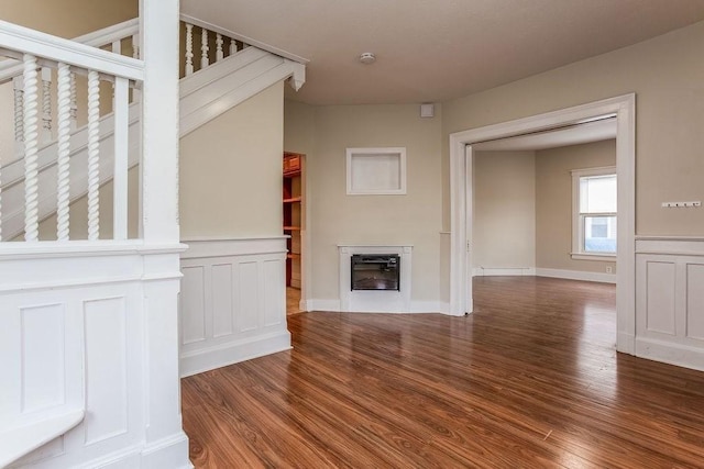67 Alexander St, Springfield, MA 01107 - unfurnished living room featuring wood finished floors, a glass covered fireplace, and wainscoting