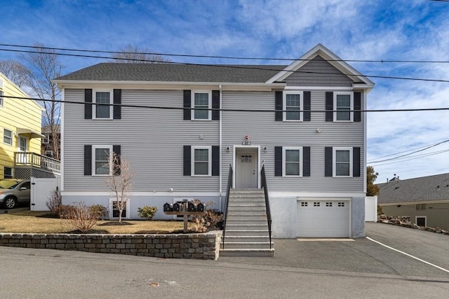 view of front of house with aphalt driveway and an attached garage