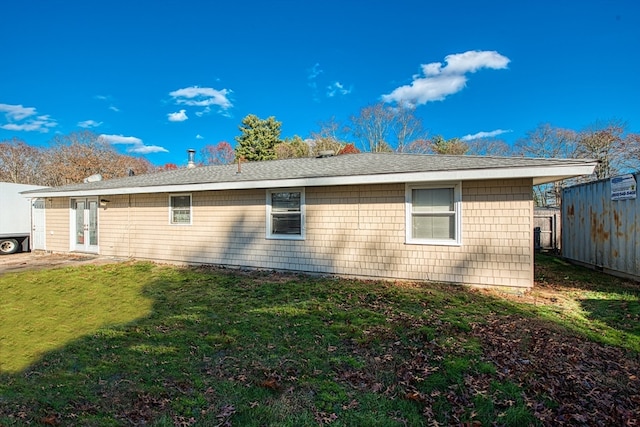 view of side of home with french doors and a yard