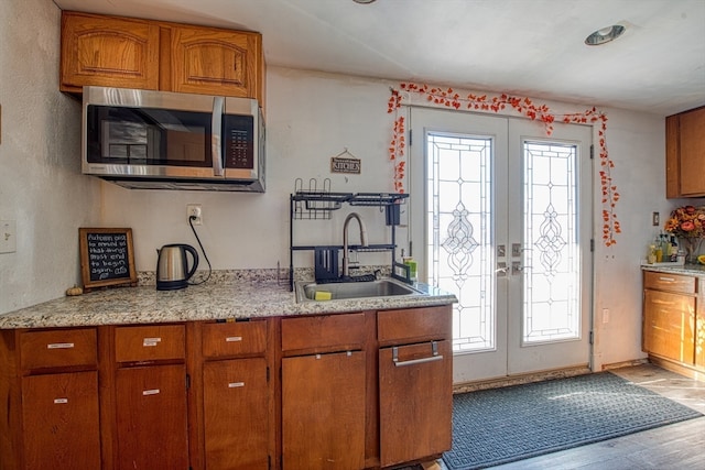 kitchen with hardwood / wood-style flooring, a healthy amount of sunlight, sink, and french doors