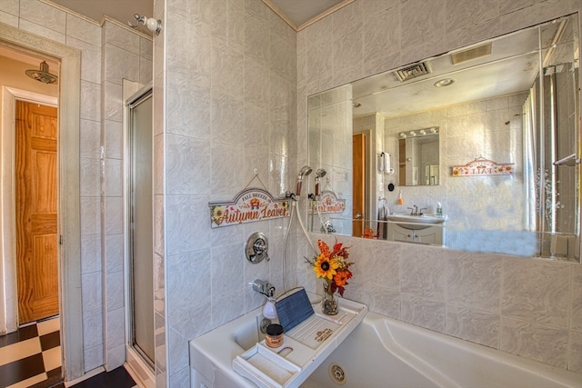 bathroom featuring separate shower and tub and tile walls