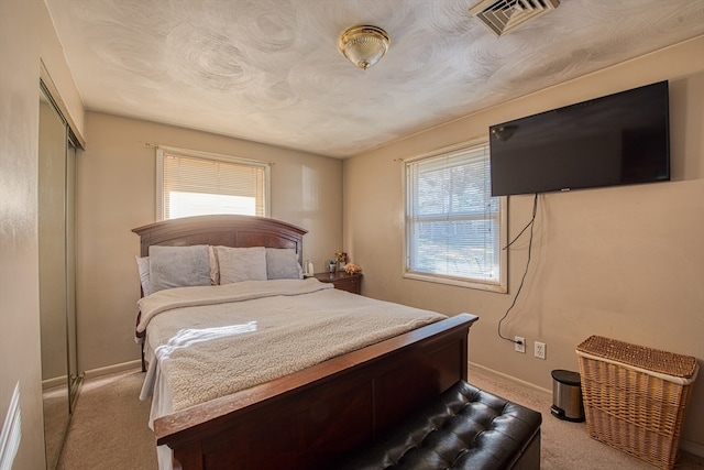 bedroom featuring a closet and light colored carpet