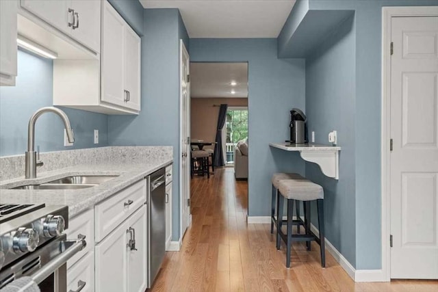 U505 Browning Ln # 505, Worcester, MA 01609 - kitchen with stainless steel appliances, light wood-style flooring, white cabinetry, and light stone countertops
