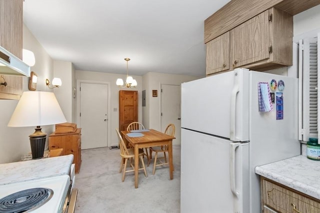 56 Jacqueline Rd Unit 12, Waltham, MA 02452 - kitchen with freestanding refrigerator, light countertops, stove, a chandelier, and decorative light fixtures