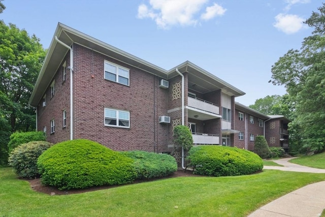 56 Jacqueline Rd Unit 12, Waltham, MA 02452 - view of property exterior featuring brick siding and a yard