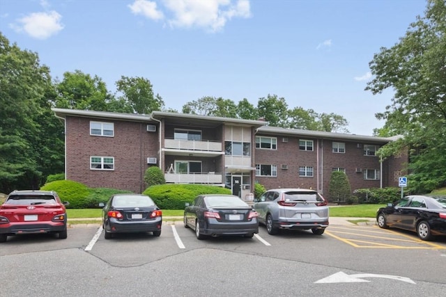 56 Jacqueline Rd Unit 12, Waltham, MA 02452 - view of building exterior featuring uncovered parking