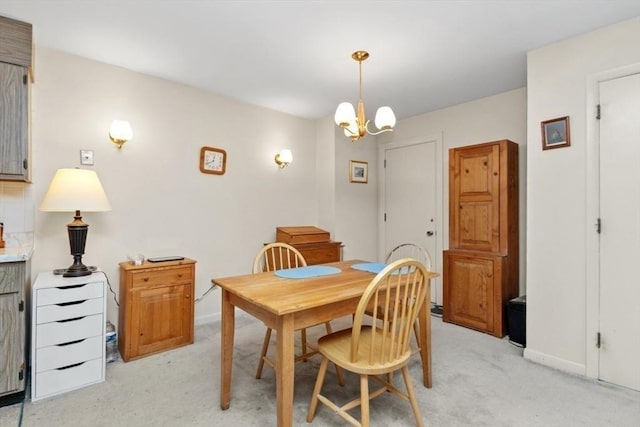 56 Jacqueline Rd Unit 12, Waltham, MA 02452 - dining area featuring light carpet, a chandelier, and baseboards