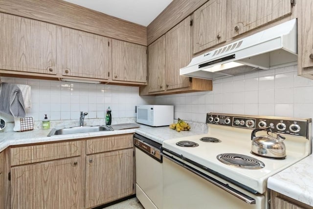 56 Jacqueline Rd Unit 12, Waltham, MA 02452 - kitchen with white appliances, under cabinet range hood, a sink, tasteful backsplash, and light countertops
