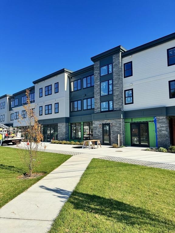 view of home's community featuring a lawn