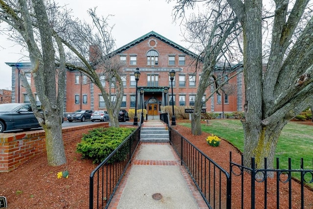 view of front facade with a chimney and fence
