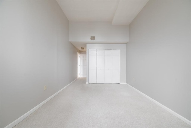 unfurnished bedroom with visible vents, baseboards, carpet flooring, and a closet