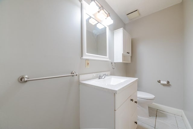 bathroom with toilet, tile patterned flooring, baseboards, and vanity