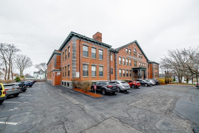 view of building exterior with uncovered parking