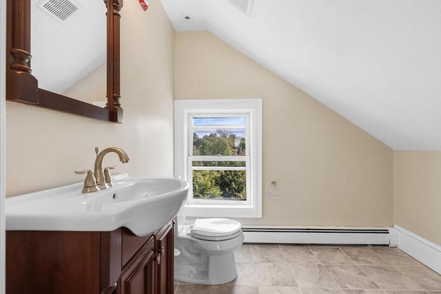 6 Windsor St, Andover, MA 01810 - bathroom with a baseboard radiator, vaulted ceiling, vanity, and tile patterned flooring