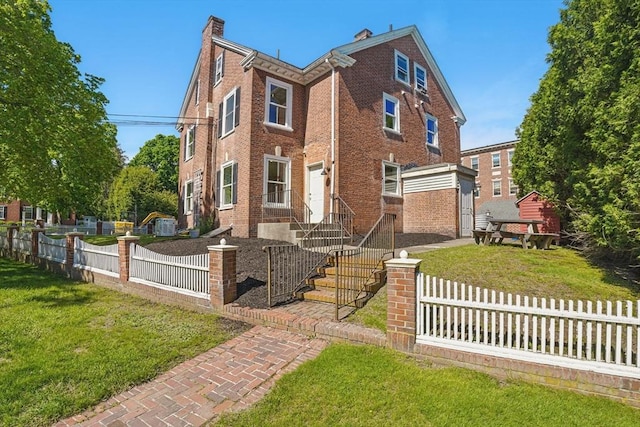 6 Windsor St, Andover, MA 01810 - view of front of home featuring a fenced front yard, brick siding, and a chimney