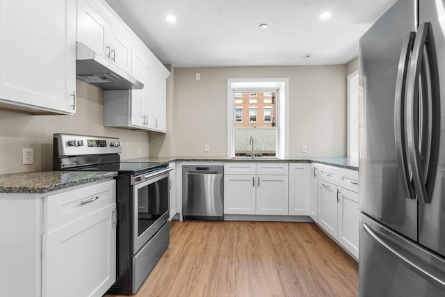 6 Windsor St, Andover, MA 01810 - kitchen with stainless steel appliances, under cabinet range hood, light wood-type flooring, white cabinets, and recessed lighting