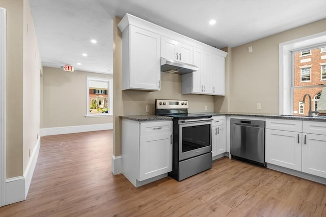 6 Windsor St, Andover, MA 01810 - kitchen featuring stainless steel appliances, under cabinet range hood, light wood-style flooring, white cabinetry, and recessed lighting