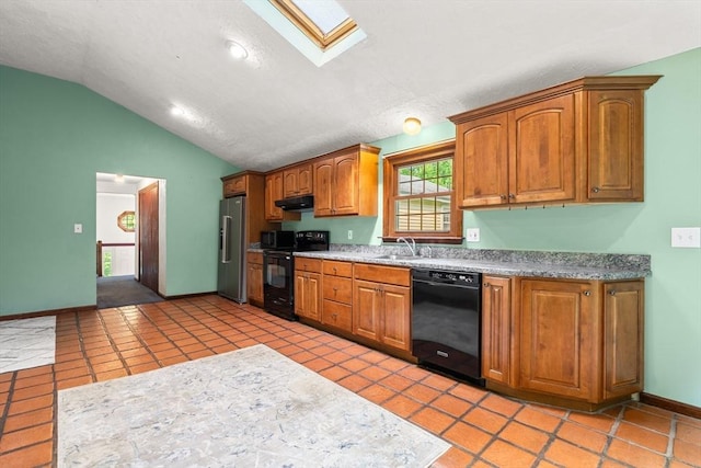 5 Ingalls Rd, Tyngsborough, MA 01879 - kitchen featuring black appliances, lofted ceiling, a skylight, brown cabinets, and under cabinet range hood