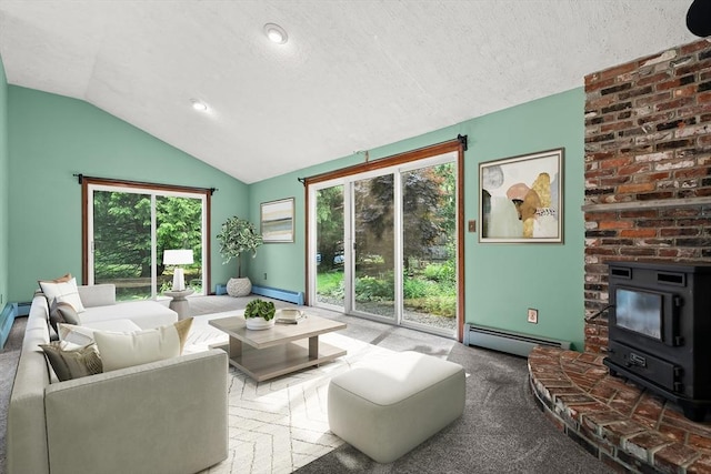 5 Ingalls Rd, Tyngsborough, MA 01879 - living area with a baseboard radiator, lofted ceiling, a wood stove, carpet floors, and a textured ceiling