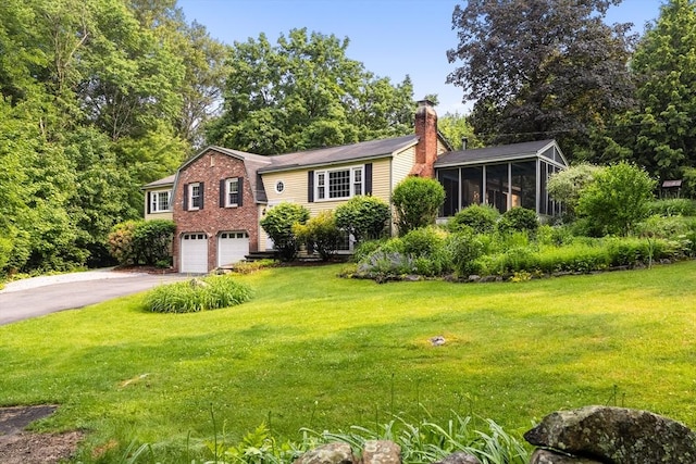 5 Ingalls Rd, Tyngsborough, MA 01879 - view of front of property featuring driveway, a chimney, a sunroom, an attached garage, and a front lawn