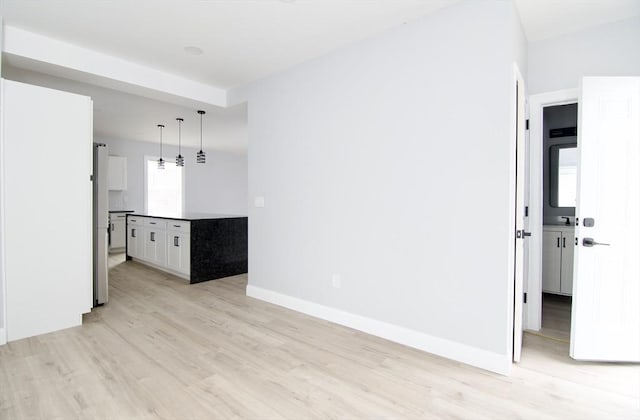664 Mckinstry Ave, Chicopee, MA 01020 - unfurnished living room featuring light wood finished floors and baseboards