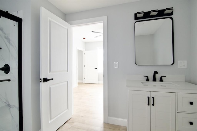 664 Mckinstry Ave, Chicopee, MA 01020 - full bath with wood finished floors, a marble finish shower, vanity, and baseboards