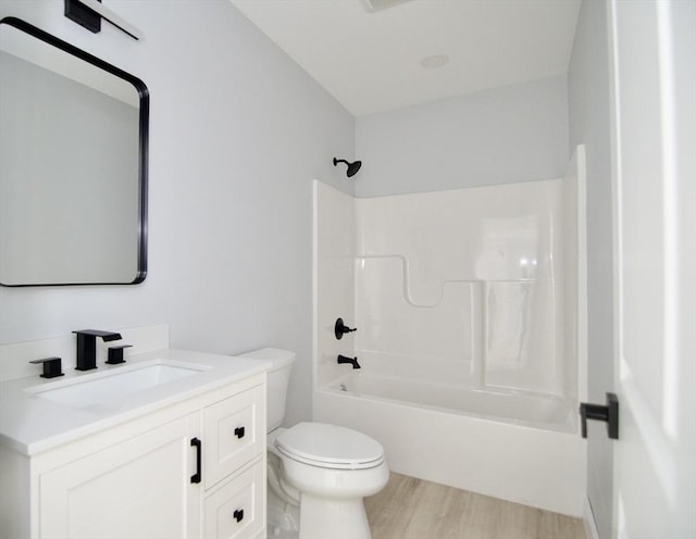 664 Mckinstry Ave, Chicopee, MA 01020 - full bath featuring toilet, tub / shower combination, vanity, and wood finished floors