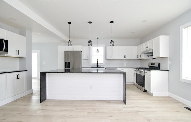 664 Mckinstry Ave, Chicopee, MA 01020 - kitchen with appliances with stainless steel finishes, backsplash, a sink, under cabinet range hood, and recessed lighting