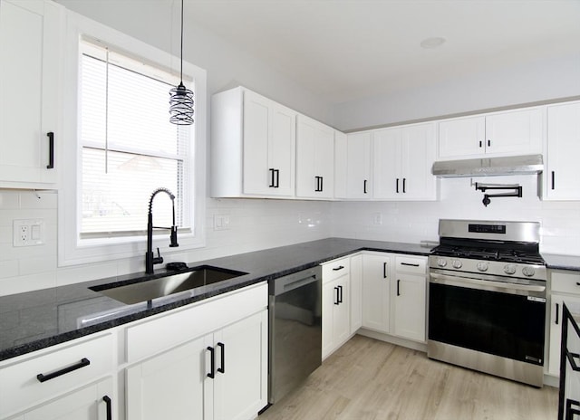 664 Mckinstry Ave, Chicopee, MA 01020 - kitchen with stainless steel range with gas stovetop, dishwashing machine, a sink, under cabinet range hood, and tasteful backsplash