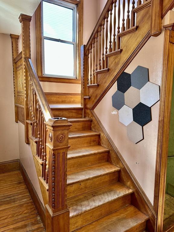 staircase with wood-type flooring