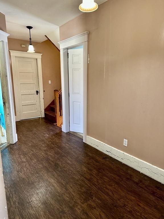 empty room featuring dark wood-type flooring