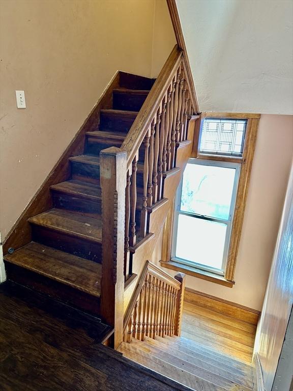 staircase featuring wood-type flooring