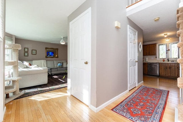 60 Spencer St Unit 60, Millis, MA 02054 - hallway featuring light wood-type flooring, baseboards, and a sink