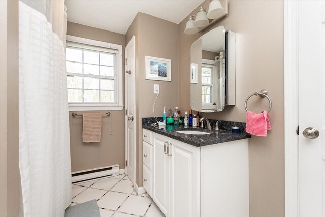 60 Spencer St Unit 60, Millis, MA 02054 - bathroom with baseboard heating, vanity, tile patterned floors, and baseboards